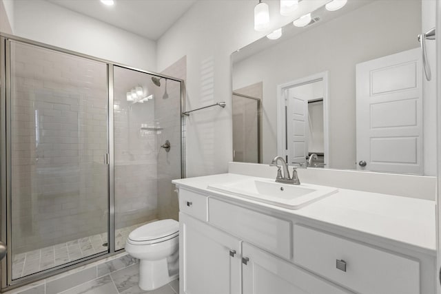 bathroom featuring walk in shower, vanity, and toilet