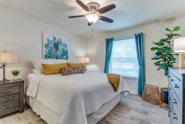 bedroom with ceiling fan and light hardwood / wood-style flooring