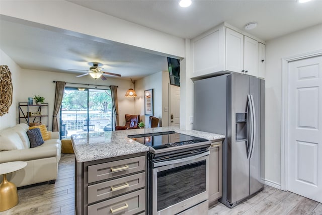 kitchen featuring gray cabinets, light hardwood / wood-style flooring, appliances with stainless steel finishes, light stone countertops, and white cabinets