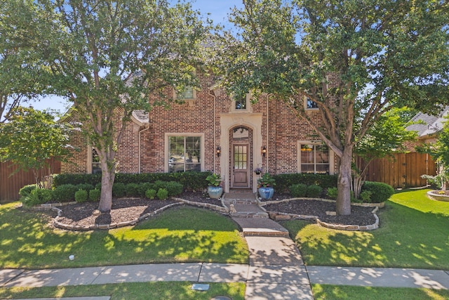 english style home with a front yard