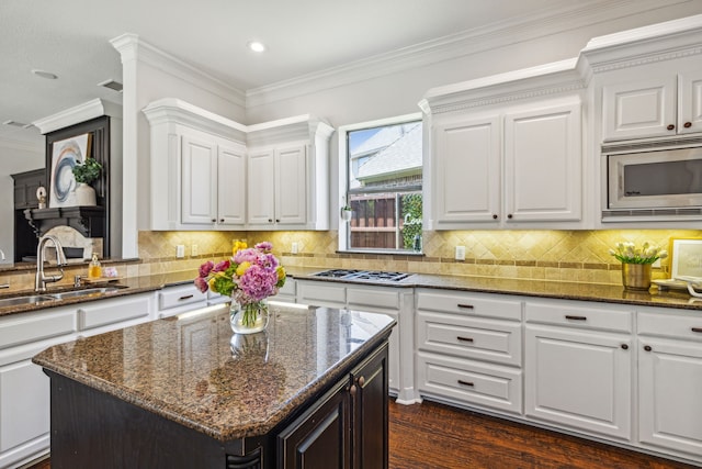 kitchen featuring white cabinetry, sink, appliances with stainless steel finishes, and a kitchen island