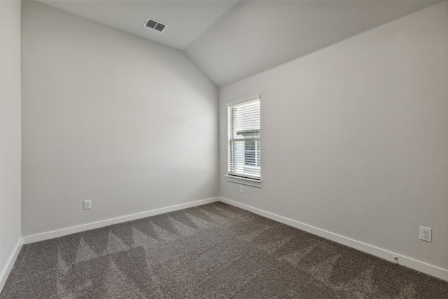 carpeted empty room with lofted ceiling