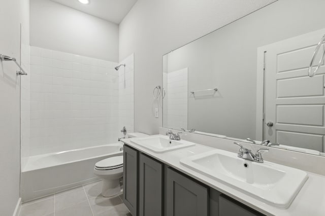 full bathroom with tiled shower / bath, vanity, toilet, and tile patterned flooring