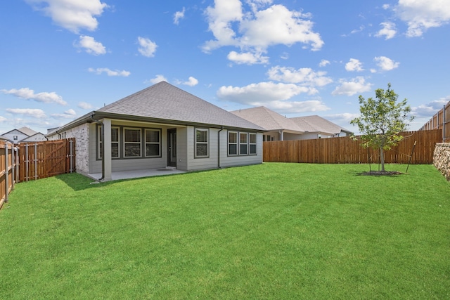 rear view of property with a lawn and a patio area