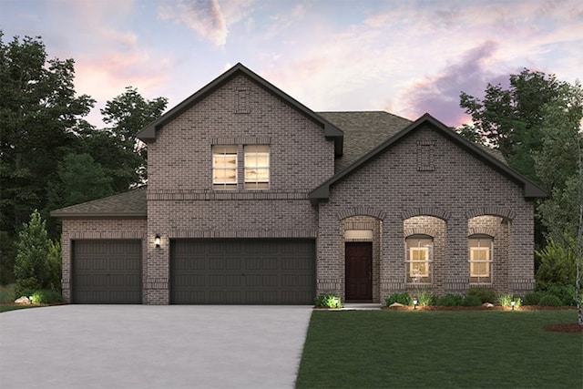 french country style house featuring a garage and a lawn