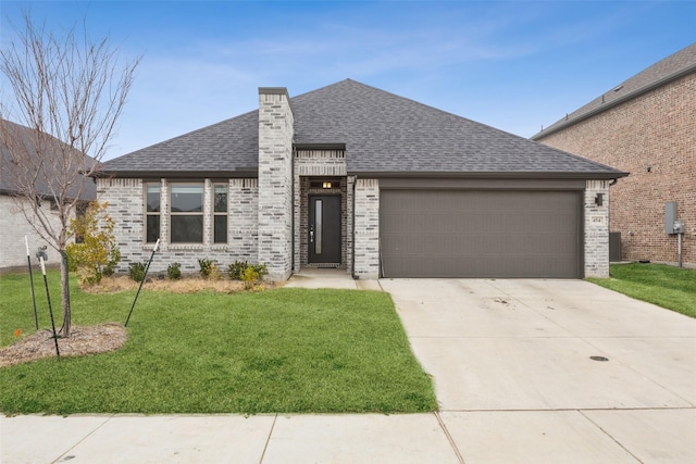 view of front of home featuring a garage and a front yard