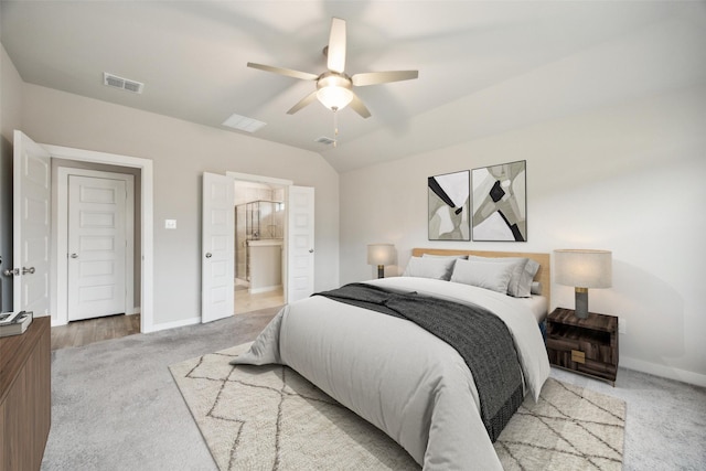 carpeted bedroom with lofted ceiling, connected bathroom, and ceiling fan