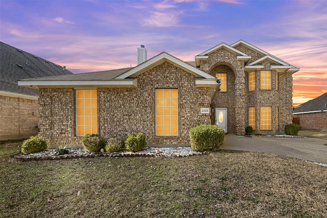 front facade with a yard