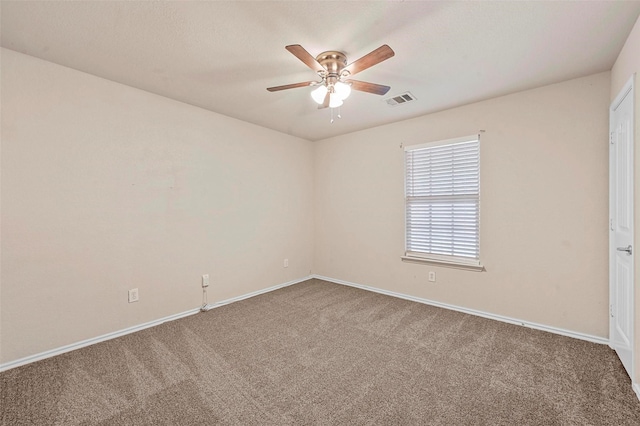 carpeted spare room featuring ceiling fan