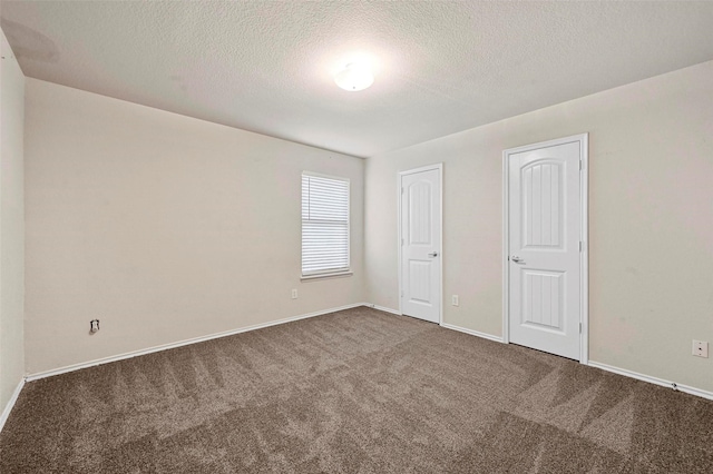 unfurnished bedroom featuring carpet floors and a textured ceiling