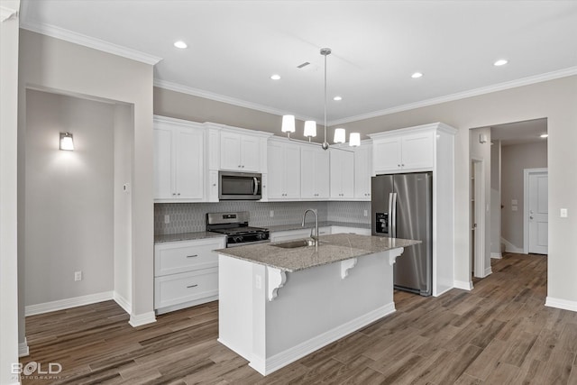 kitchen featuring sink, appliances with stainless steel finishes, a kitchen island with sink, white cabinetry, and light stone countertops