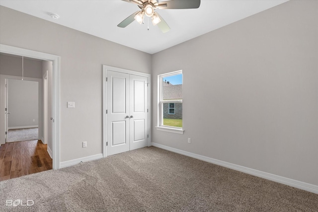 unfurnished bedroom featuring carpet, ceiling fan, and a closet