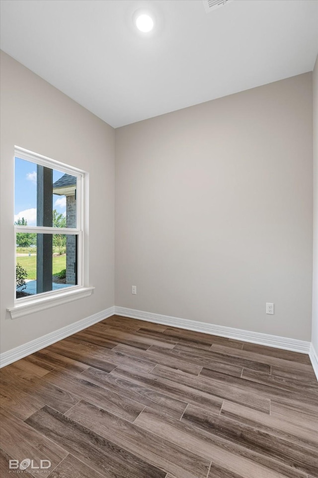 spare room featuring hardwood / wood-style floors