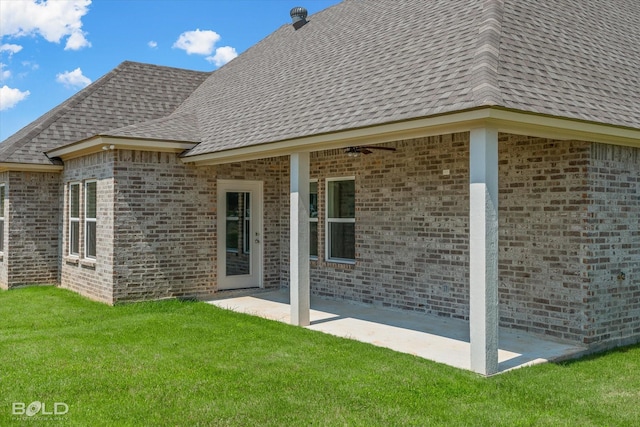 rear view of property featuring a yard and a patio