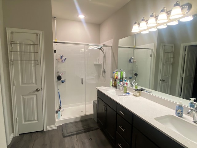 bathroom featuring vanity, a shower with shower door, and hardwood / wood-style floors