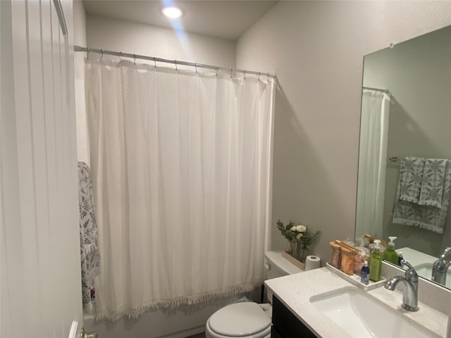 full bathroom with vanity, shower / tub combo, and toilet