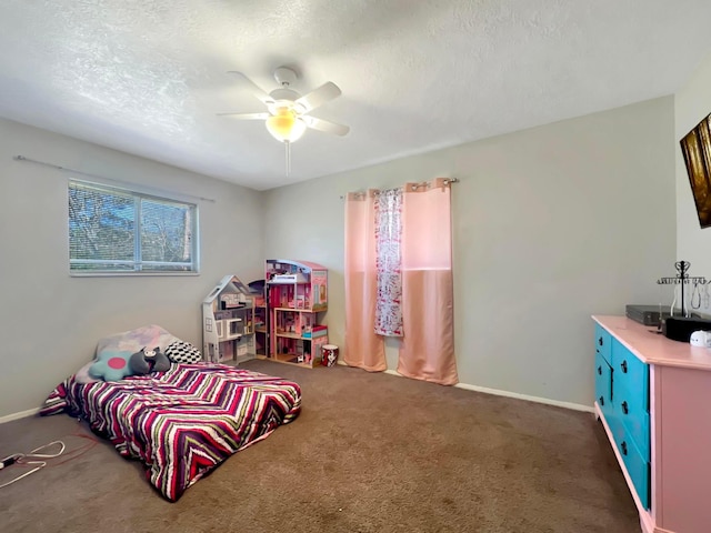 carpeted bedroom with ceiling fan and a textured ceiling