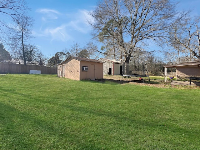 view of yard featuring a storage unit and a trampoline