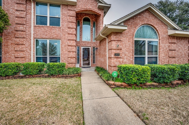 property entrance with a yard