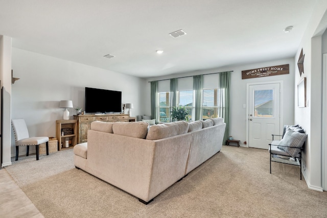 living room featuring light carpet