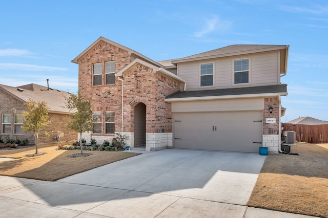 view of front property with a garage and central AC