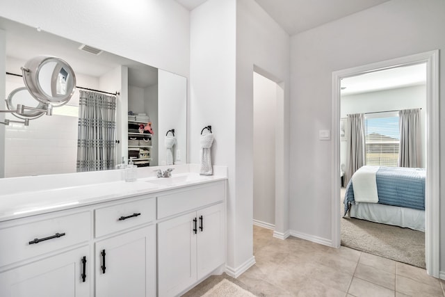 bathroom featuring vanity, tile patterned floors, and walk in shower