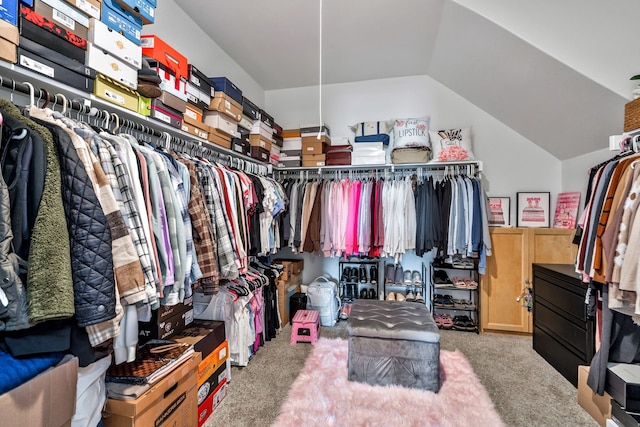 walk in closet featuring carpet flooring and vaulted ceiling