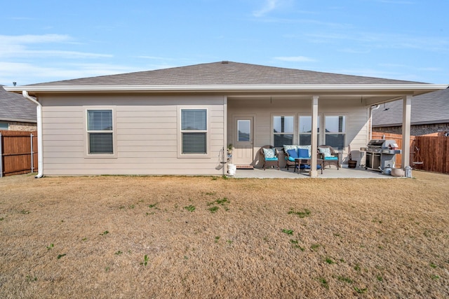 rear view of property featuring a patio area and a lawn