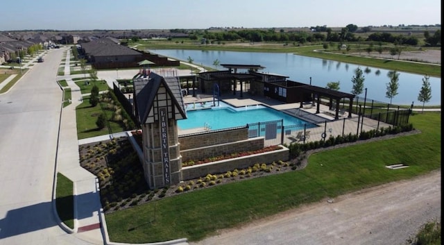 view of swimming pool with a water view and a patio area