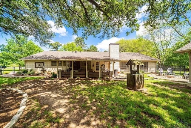 back of house with a lawn and a patio area