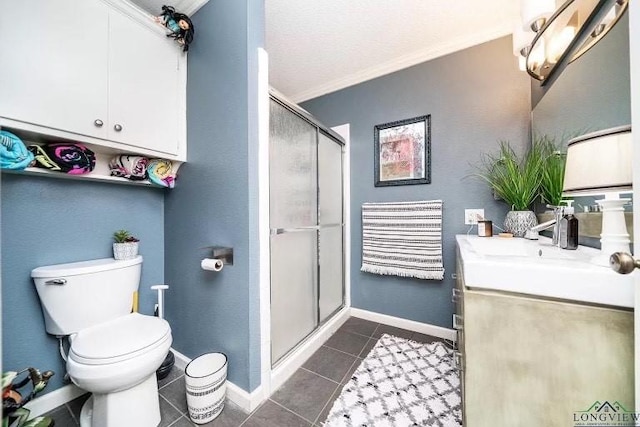 bathroom featuring tile patterned flooring, vanity, toilet, a shower with door, and crown molding