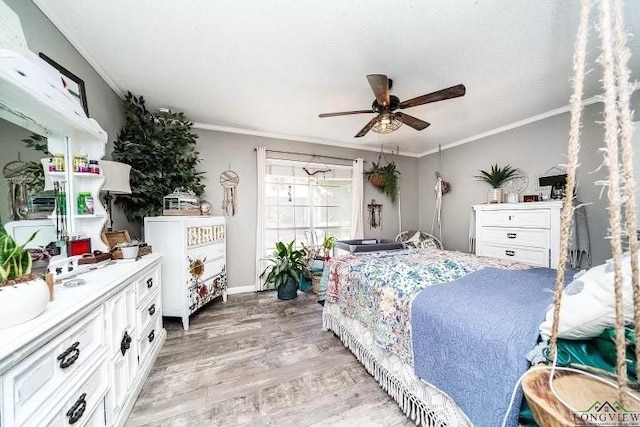 bedroom featuring ornamental molding, ceiling fan, and light wood-type flooring