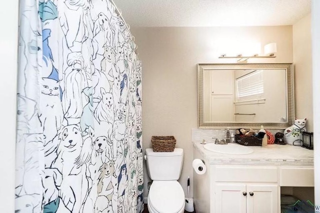 bathroom featuring vanity, a textured ceiling, curtained shower, and toilet