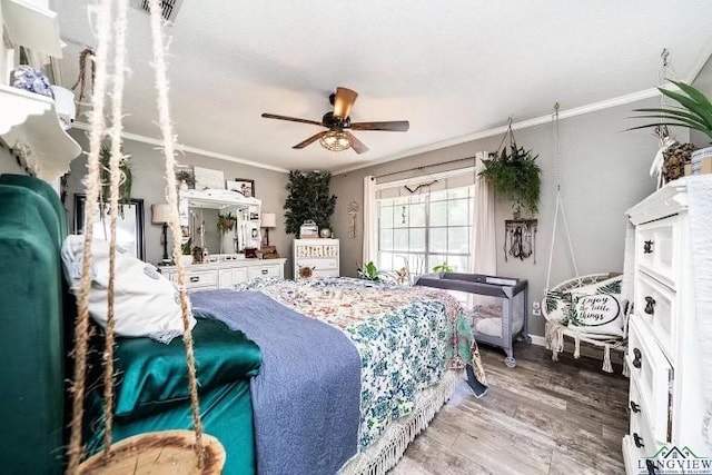 bedroom featuring crown molding, ceiling fan, and hardwood / wood-style flooring