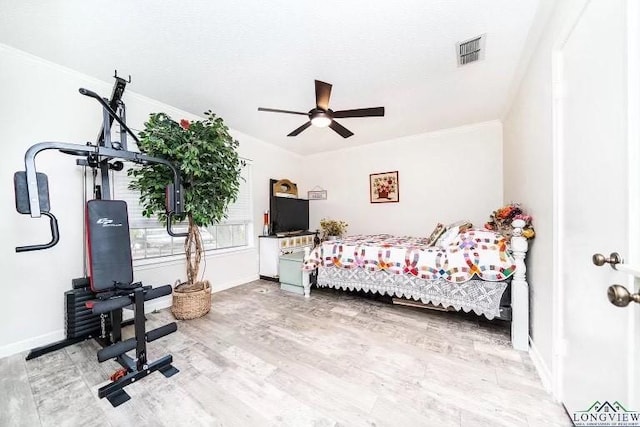 bedroom with wood-type flooring and crown molding