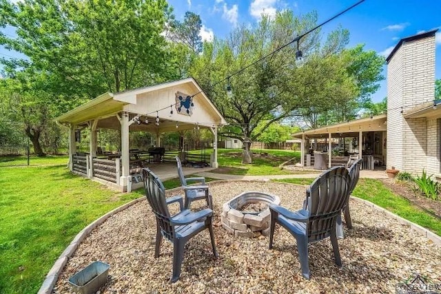 view of yard with a gazebo and an outdoor fire pit