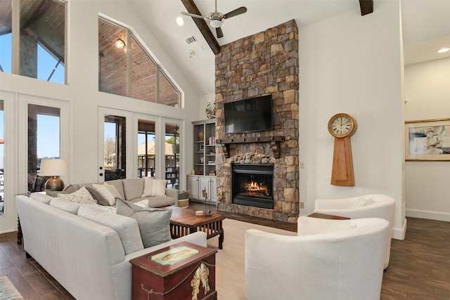 living room featuring french doors, a stone fireplace, high vaulted ceiling, dark hardwood / wood-style flooring, and ceiling fan