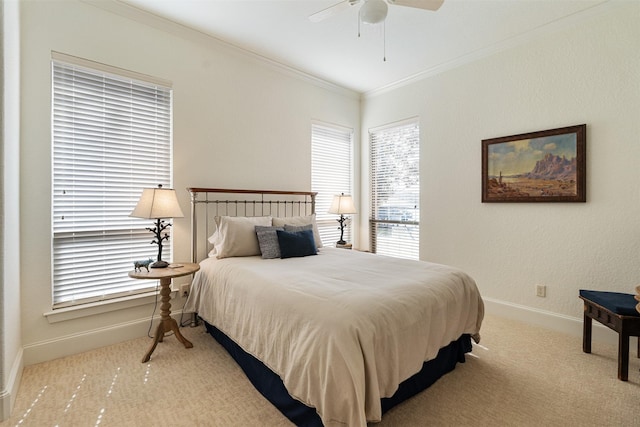 bedroom featuring crown molding, ceiling fan, and light carpet