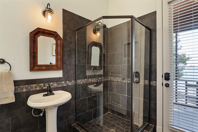 bathroom featuring sink and a shower with shower door