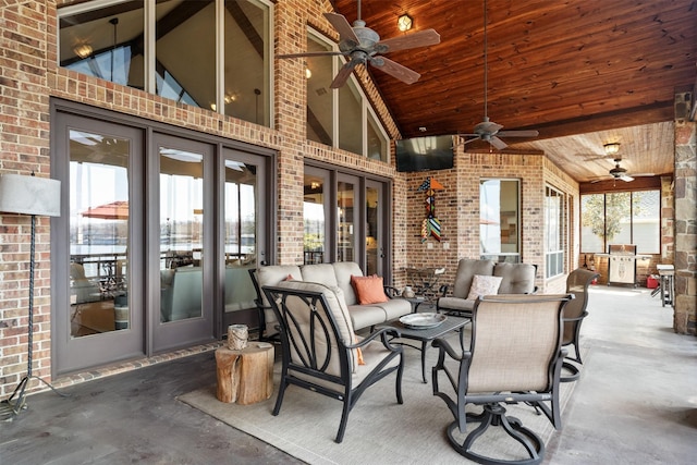 view of patio featuring exterior kitchen, an outdoor hangout area, and ceiling fan