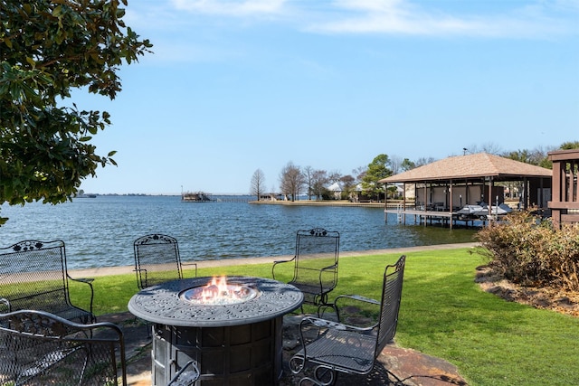 view of patio with a fire pit, a gazebo, and a water view