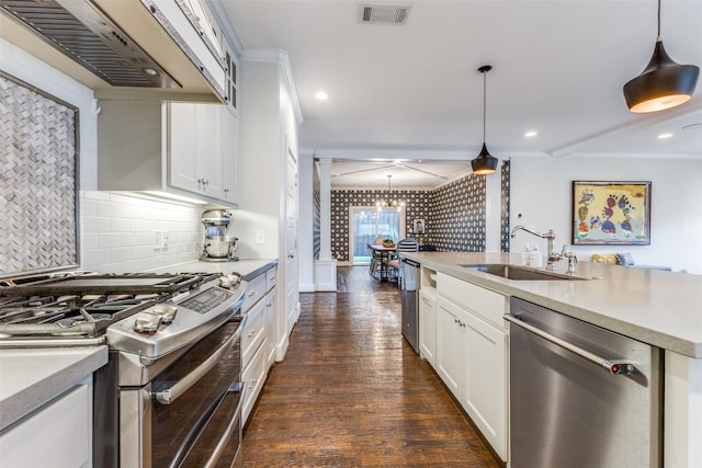 kitchen featuring hanging light fixtures, custom exhaust hood, appliances with stainless steel finishes, and sink