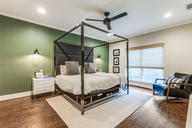 bedroom featuring crown molding, dark wood-type flooring, and ceiling fan