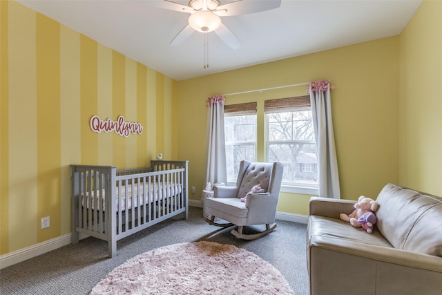 bedroom featuring a crib, carpet flooring, and ceiling fan