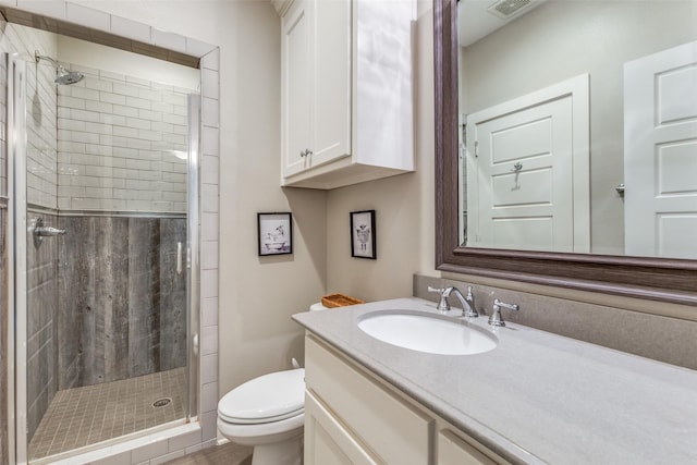 bathroom featuring walk in shower, vanity, and toilet