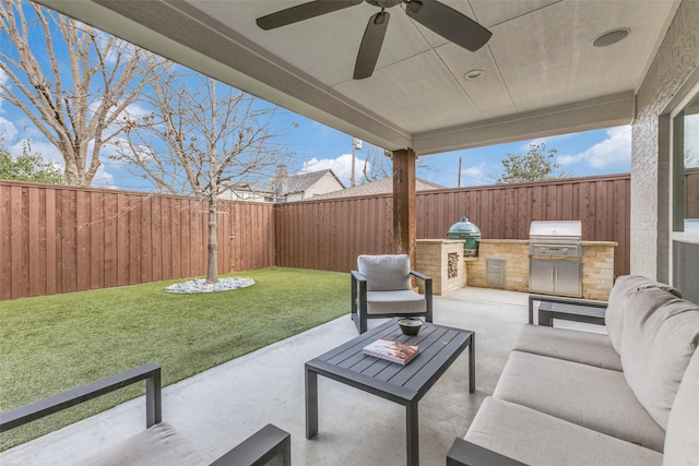 view of patio featuring grilling area, outdoor lounge area, ceiling fan, and an outdoor kitchen