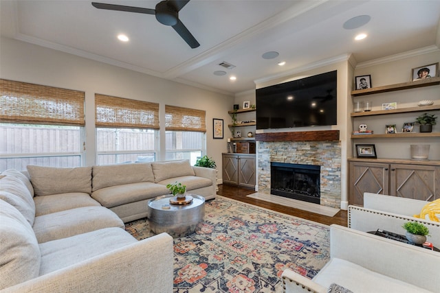 living room with hardwood / wood-style floors, crown molding, a fireplace, and ceiling fan