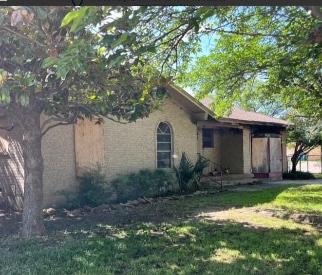 view of property exterior with a lawn