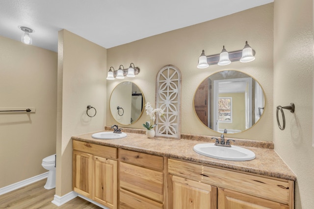 bathroom featuring vanity, hardwood / wood-style floors, and toilet