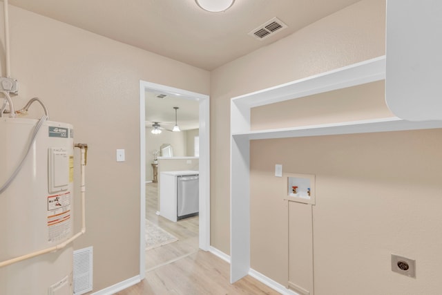 laundry room featuring electric dryer hookup, hookup for a washing machine, water heater, and light wood-type flooring